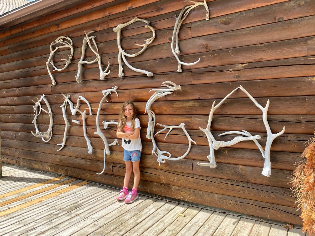 our youngest standing next to the many beautifully hand made signs